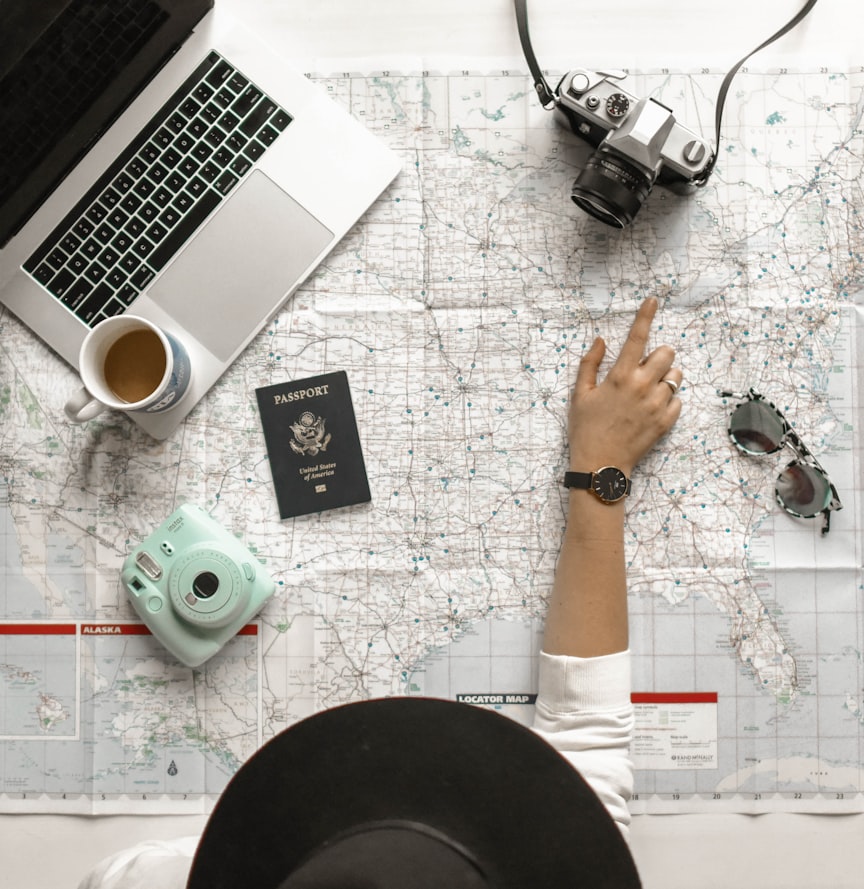 Open notebook and travel map with coffee